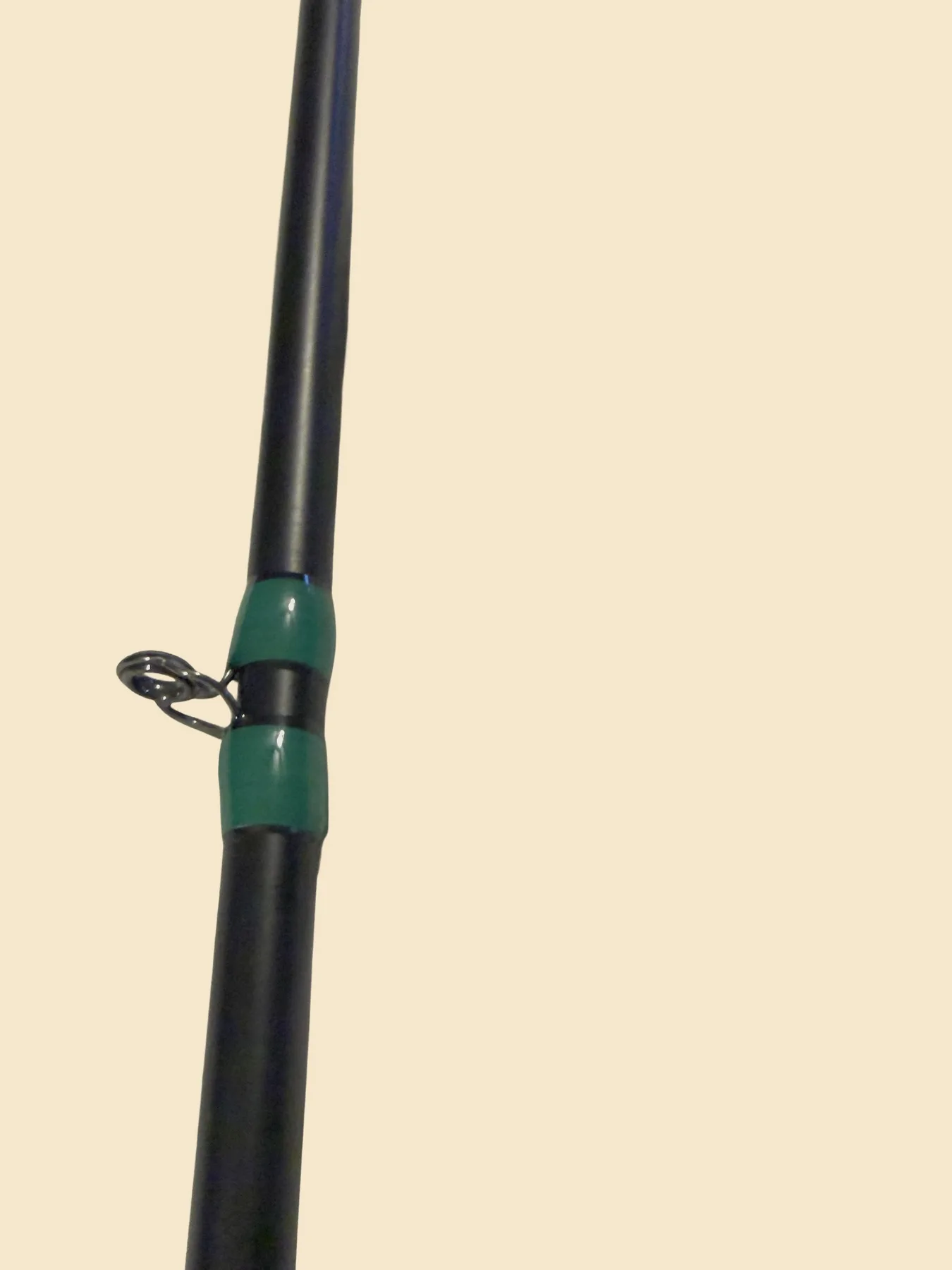 Mid guide wrap detail on a black Donkey Styx blank with green trim
