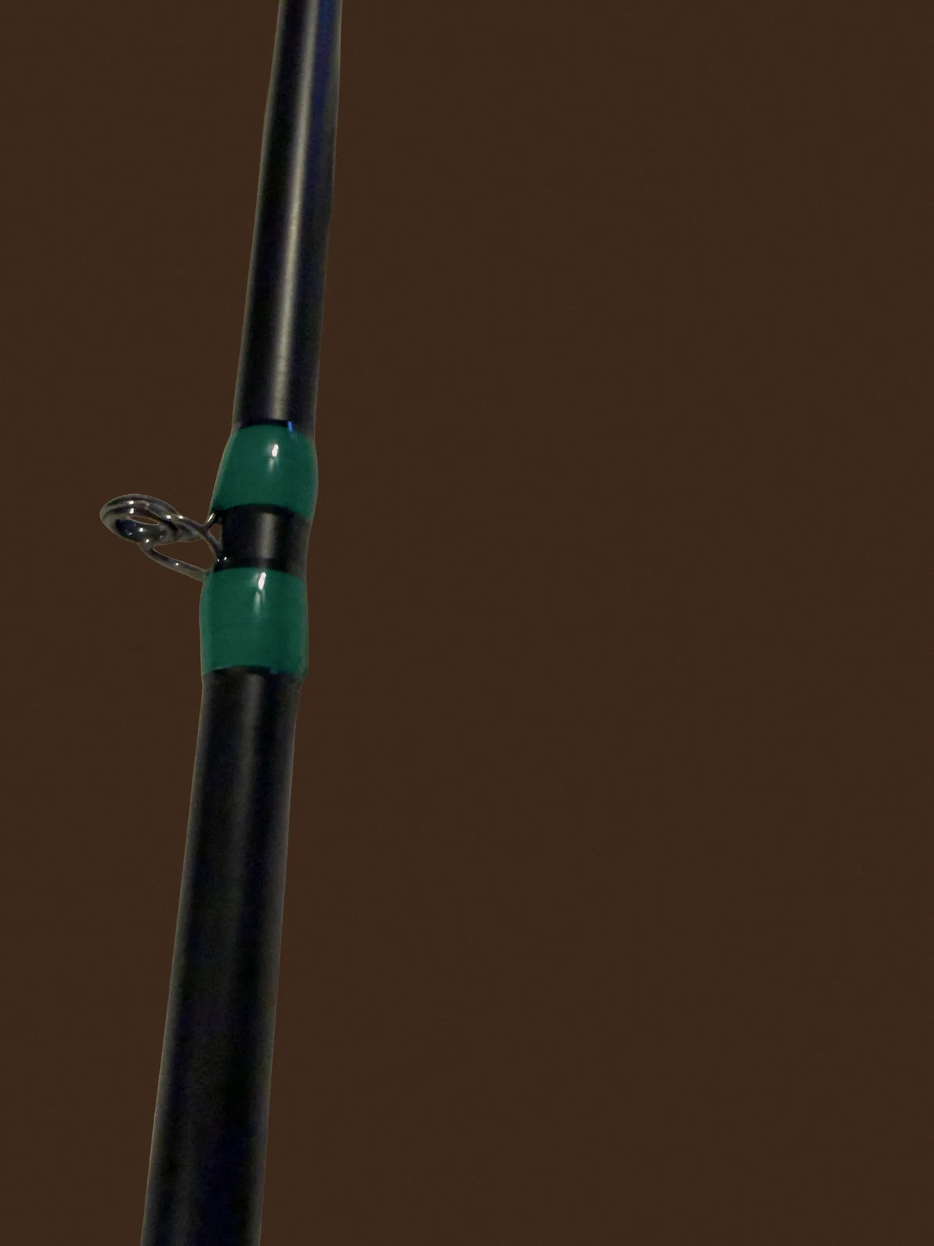 Mid guide wrap detail on a black Donkey Styx blank with green trim