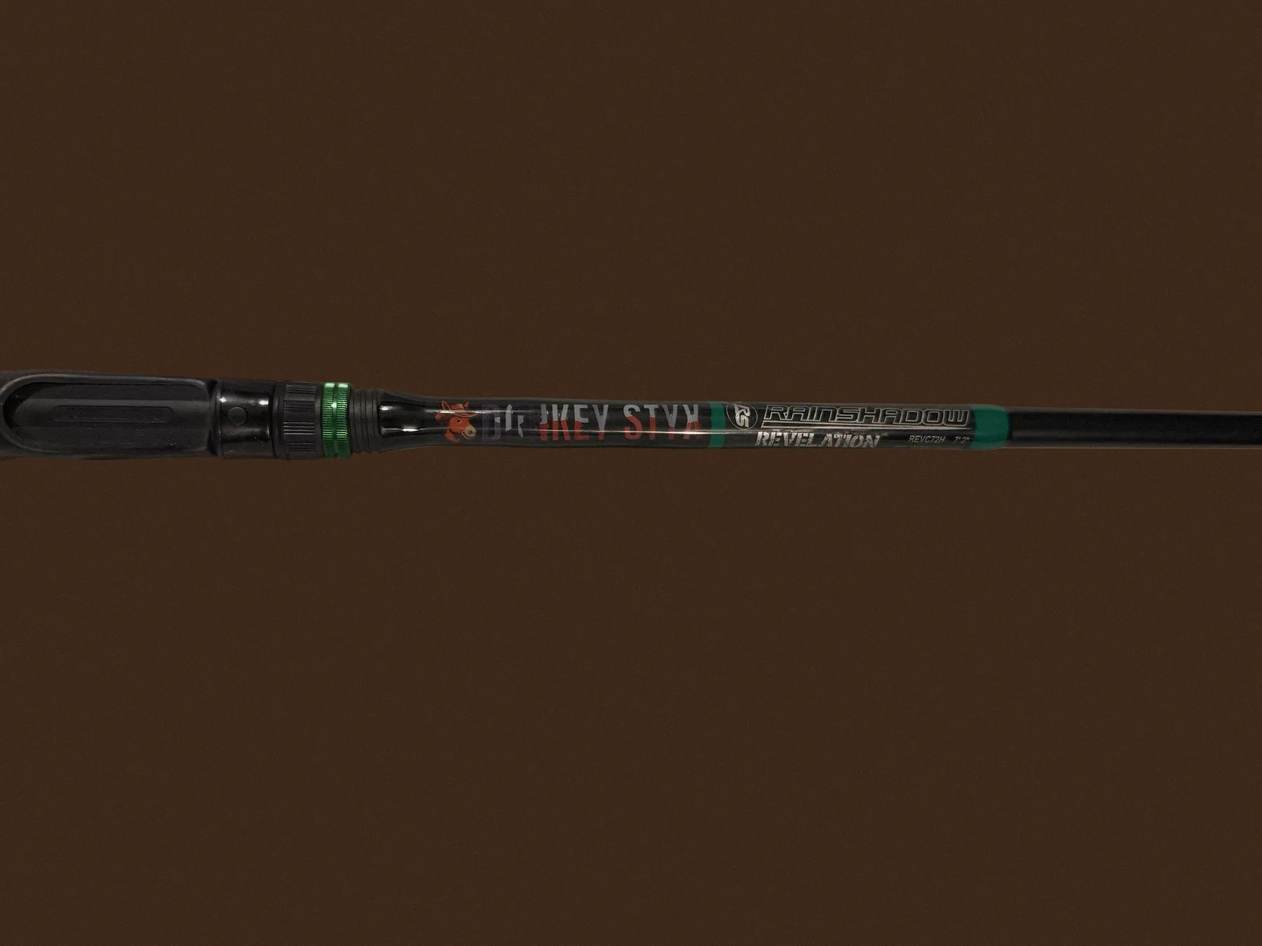 A finished custom Donkey Styx rod, Dr Mikey Styx wrap, black blank with green trim