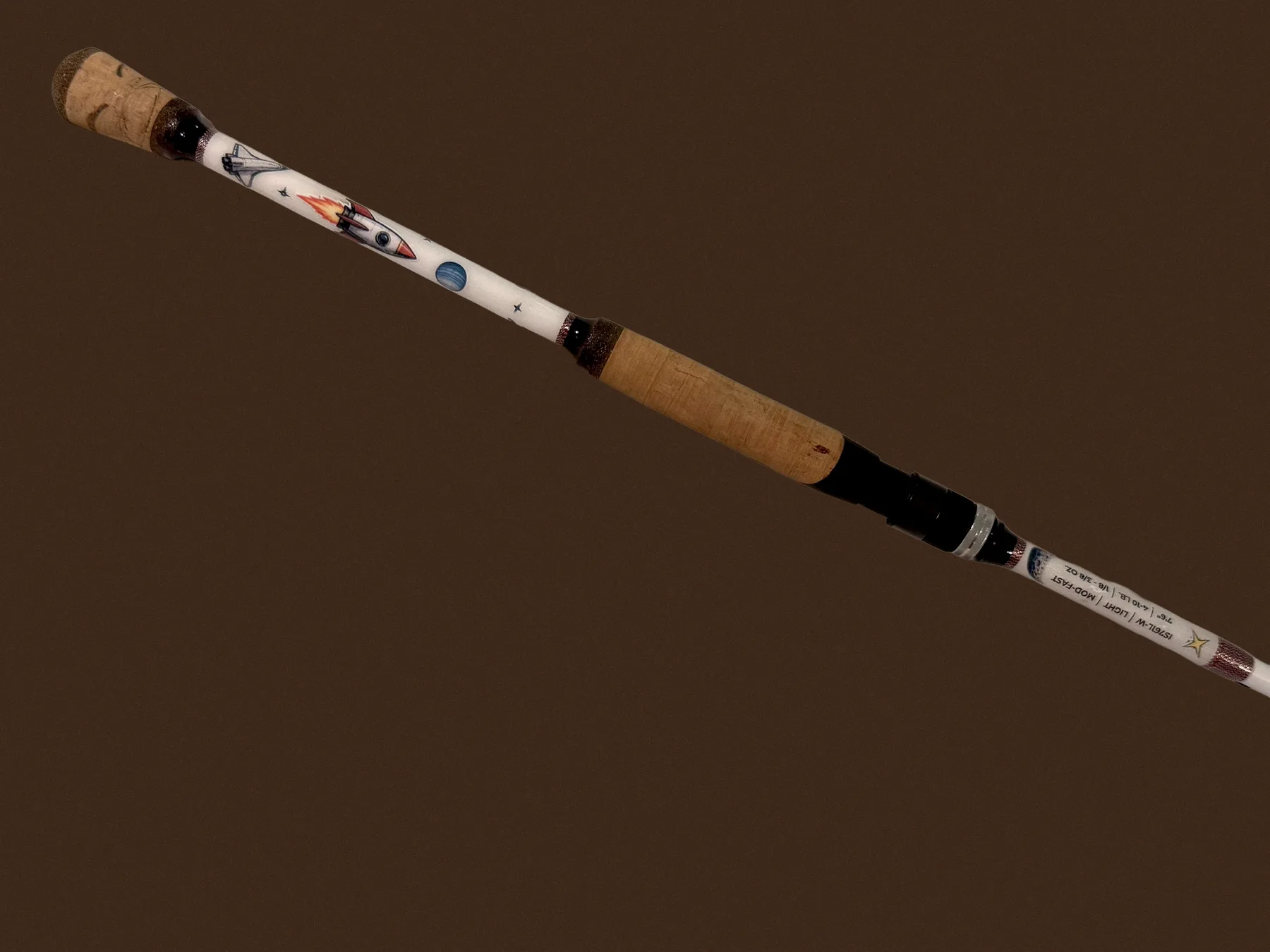 Same Donkey Styx rod, straightened, brightened, and moved off the wrinkled sheet onto a clean brand-brown surface